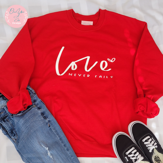 Love Never fails white design on Red Sweatshirt I Once Upon A Celeb Design www.onceuponacelebdesign.com