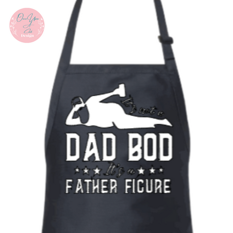 Black Apron With White Design of It's not a Dad Bod Its a Father Figure BY Once Upon A Celeb Design