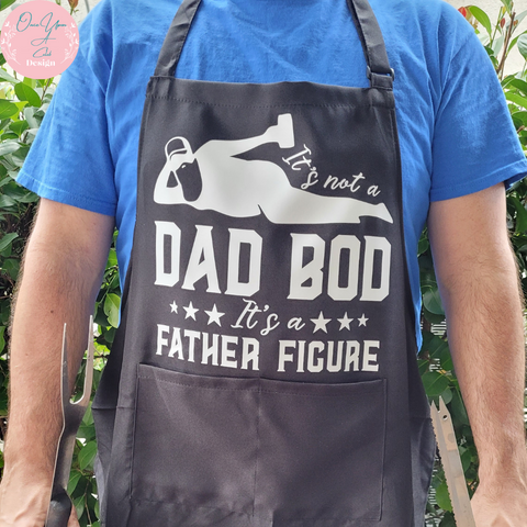 Black Apron With White Design of It's not a Dad Bod Its a Father Figure BY Once Upon A Celeb Design